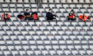 Medical staff sit in the stands.