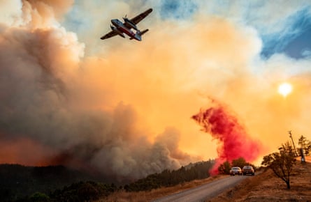 An aircraft drops fire retardant on a ridge during the Walbridge fire, part of the larger LNU Lightning Complex fire.