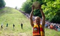 Dylan Twiss, from Perth Australia, celebrates after winning race 2, at the annual cheese rolling at Cooper's Hill in Brockworth, Gloucestershire