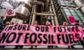Protesters stand outside the Lloyd’s building in the City holding a pink banner that reads: "Insure our future, not fossil fuels"
