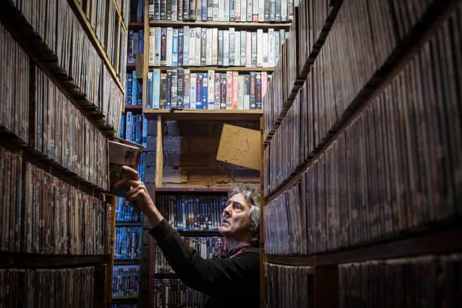 Derek returns DVDs into their place among the library