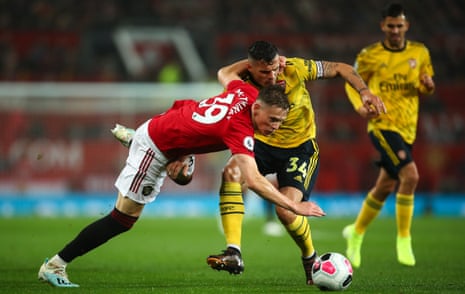Scott McTominay of Manchester United and Arsenal’s Granit Xhaka tussle for the ball at Old Trafford on Monday night. 