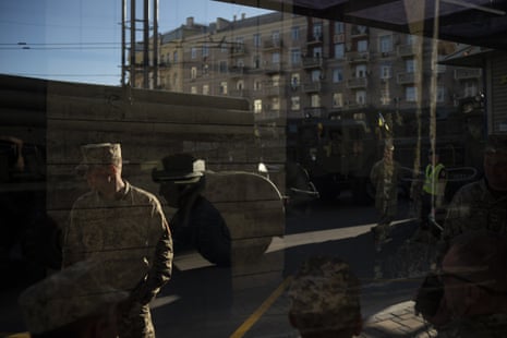 Soldiers wait with military vehicles before a rehearsal for the Independence Day military parade in Kiev
