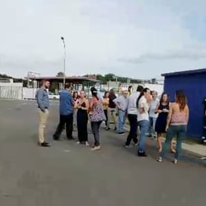 Residents gather outside during the evacuation in Noumea.