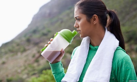 Young woman drinks protein shake.
