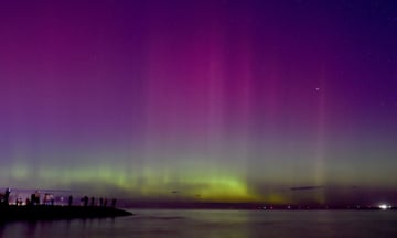 People watch the the aurora australis – or the southern lights – at Port Phillip Bay in Melbourne on Saturday