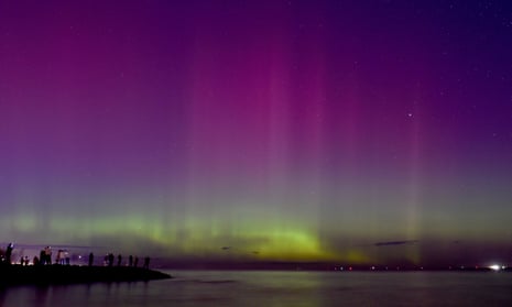People watch the the aurora australis – or the southern lights – at Port Phillip Bay in Melbourne on Saturday