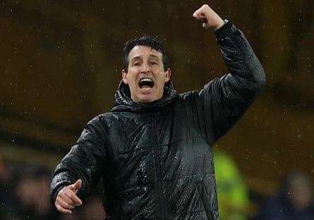 A sodden Unai Emery gesticulates on the touchline.