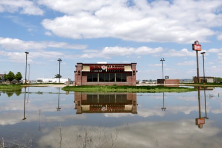 A Wendy’s hamburger restaurant in Percival, Iowa, is reflected in floodwaters from the Missouri River.