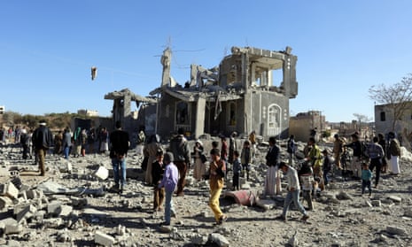 People survey the damage after an alleged Saudi-led airstrike in Sana’a