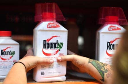 a person grabbing a bottle