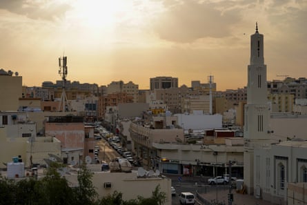 The Al Mansoura skyline against a sunset.
