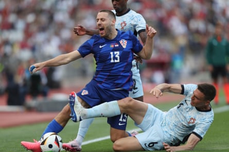 Croatia’s Nikola Vlasic is tackled by Portugal’s Joao Palhinha during their friendly on 8 June 2024.
