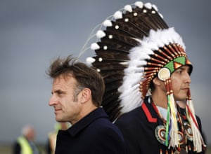 Emmanuel Macron walks on after being greeted by Steven Crowchild of the Tsuut’ina First Nation, at Calgary airport.