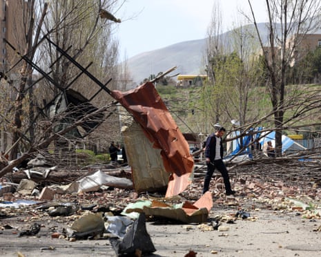 People walk amid the debris after US-Israeli airstrikes on Shahid Beheshti university in Tehran on Saturday.