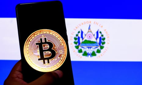 a bitcoin image on a smartphone held up against the El Salvador flag