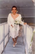 Woman in white top and white skirt holding flowers on boat ganngway