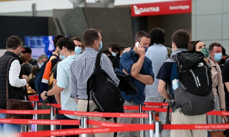 Travellers queue at the Qantas departure terminal at Sydney domestic airport