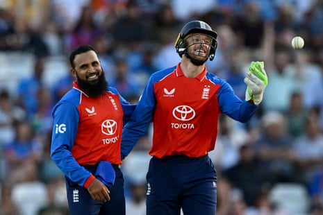 Adil Rashid of England celebrates with Jos Buttler after dismissing Arshdeep Singh of India.