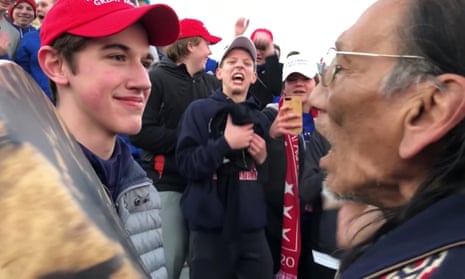A student from Covington Catholic high school standing in front of Native American Vietnam veteran Nathan Phillips in Washington DC on 18 January.