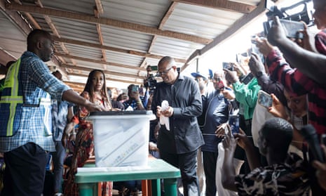 In this file photo taken on February 25, 2023 Labour Party presidential candidate Peter Obi (C) casts his ballot at a polling station in Amatutu, during Nigeria's presidential and general election