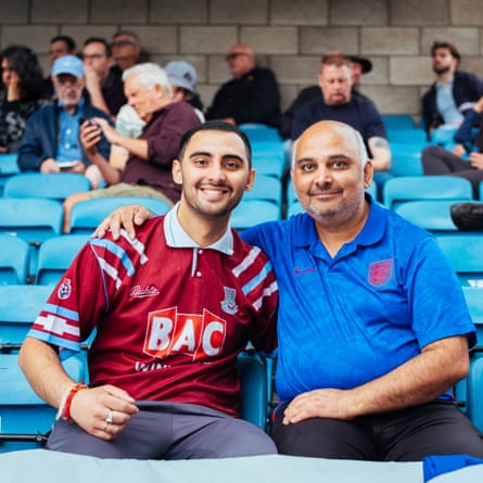 Father and son West Ham supporters sitting together