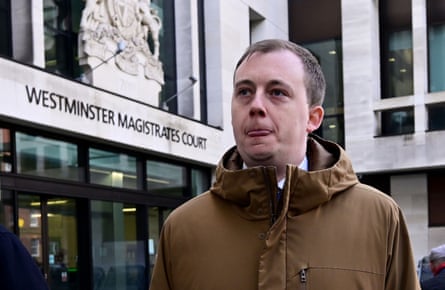Christopher Berry in a brown coat outside court