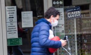 A man walks past in a closed shop in Melbourne on Wednesday.