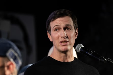 Kushner stands behind a microphone.
