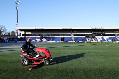 A groundsman prepares the pitch at Moss Rose.