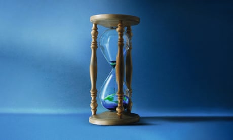 A sand timer with most of the sand, which is coloured to look like Earth from space, in the bottom