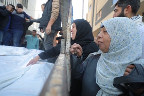 Relatives of the Palestinians killed in Israeli attack on Nuseirat refugee camp, mourn in Gaza City, 11 December.