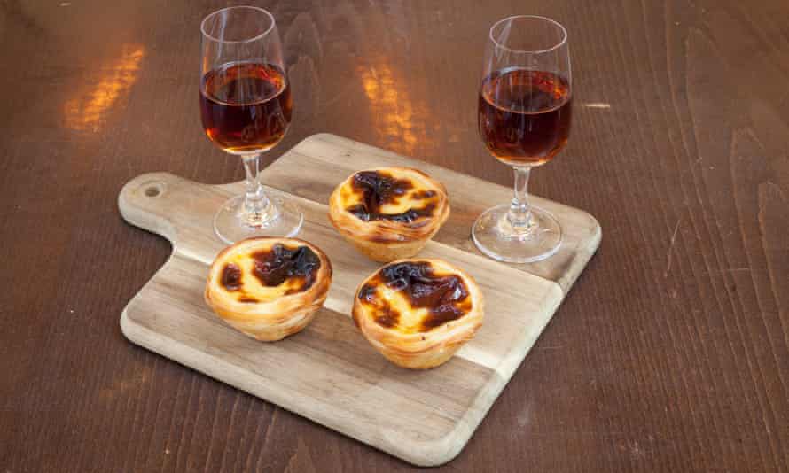 ‘Burnished tarts in their cups of pure flaky pastry’: pastéis de nata, and a couple of glasses of madeira.