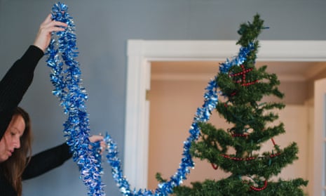Woman dressing a Christmas tree