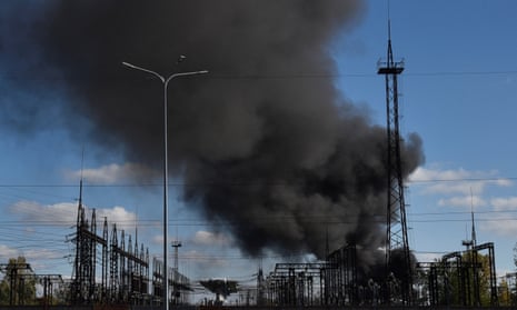 Smoke rises over power lines in Lviv after Russian missile strikes on the city’s electricity substations.