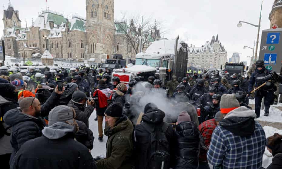Canadian police officers face off with protesters on Parliament Hill, as they work to restore normality to the capital, on Saturday.