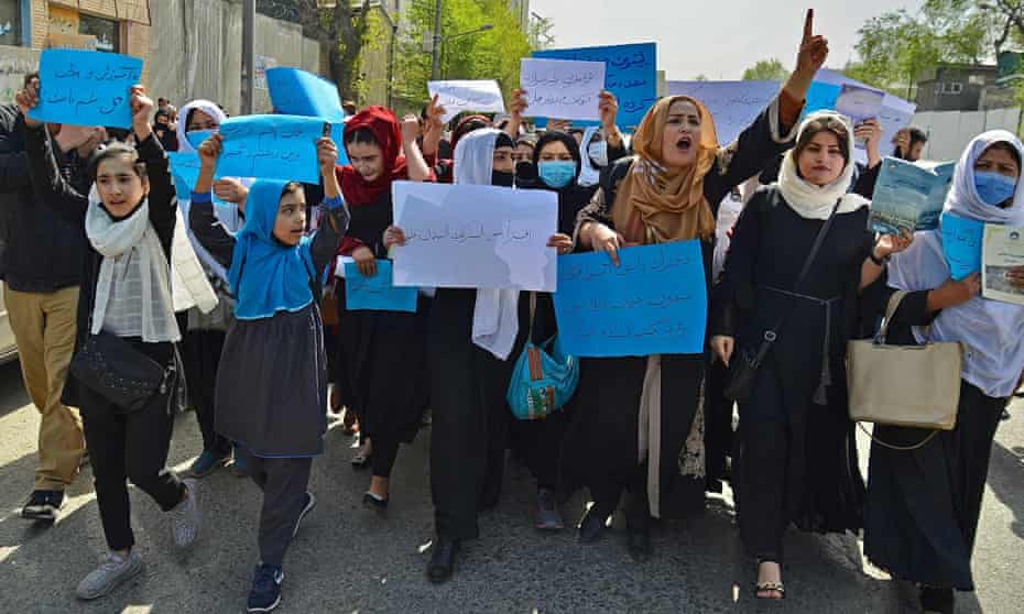 Afghan women and girls take part in a protest in front of the Ministry of Education in Kabul on 26 March
