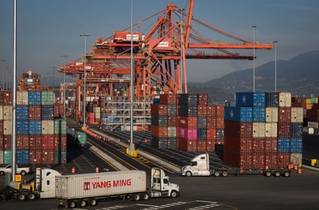 A truck carries a cargo container at the Port of Vancouver.