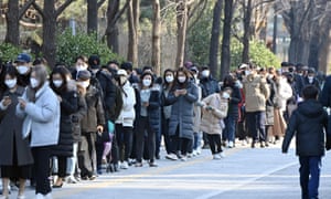 People wait in line to get Covid-19 tests at a testing centre in Seoul on 14 December.