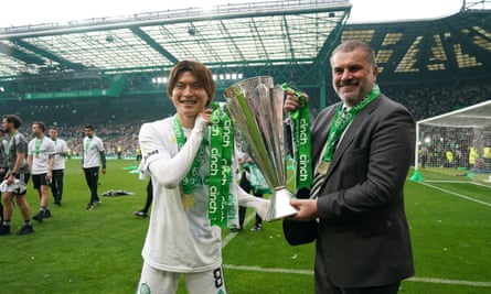 Ange Postecoglou and Kyogo Furuhashi pose with the Premiership trophy at Celtic Park.