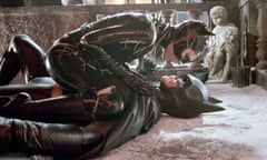 Michael Keaton as Batman lays on the floor as Michelle Pfeiffer playing Catwoman straddles him in a scene from Batman Returns.