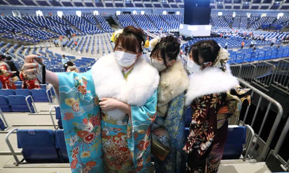 Young Japanese women dressed in colourful kimonos take selfies before a ceremony marking the Coming of Age Day at Yokohama Arena, Japan on 11 January 2021. 