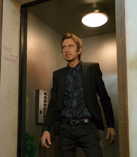 A man in black exiting a lift.