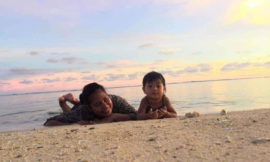 Bwerere Sandy Tebau and her daughter lie in the water in Kiribati, in the central Pacific.