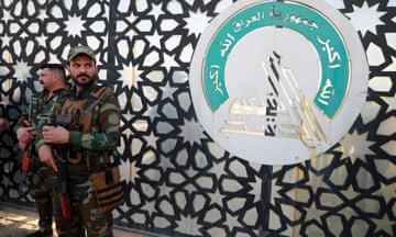 Members of Iraq's Hashed al-Shaabi stand guard at their HQ
