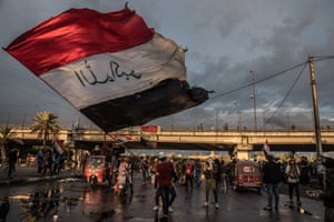 A man waving the Iraqi flag during a symbolic funeral march for a protester killed in clashes with security forces the previous day. Baghdad, 21 January 2020