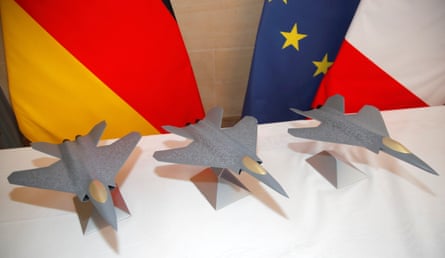Scale models of the Franco-German-Spanish future combat air system with flags in the background