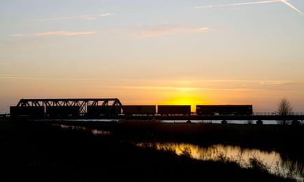 A freight train crosses fenland near Ely.
