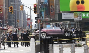 A car rests on a security barrier in New York’s Times Square after driving through a crowd of pedestrians Thursday.