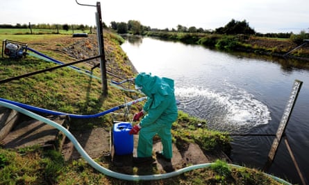 An Environment Agency worker on the banks of the Trent in Staffordshire in 2021 after it was contaminated with untreated sewage and cyanide.